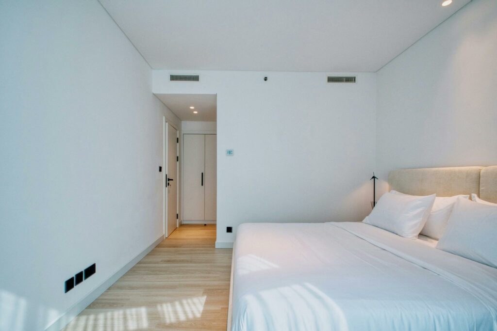 A bright and minimalistic bedroom with contemporary furnishings and decor.